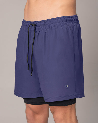 Pantaloneta deportiva con bolsillo lateral con bóxer interno#color_522-estampado-camuflado-azul