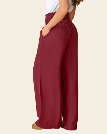 Pantalón bota ancha con nido de abeja en cintura#color_c55-vino